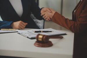 Lawyer, legal advisor, businessman brainstorming information on agreement details Business contracts in legal processing books for accuracy in contract documents. joint financial investment. photo