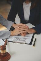 Lawyer, legal advisor, businessman brainstorming information on agreement details Business contracts in legal processing books for accuracy in contract documents. joint financial investment. photo