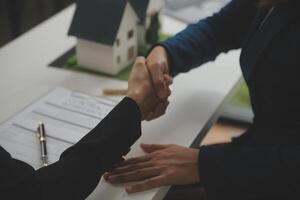 Business Signing a Contract Buy - sell house, insurance agent analyzing about home investment loan Real Estate concept. photo