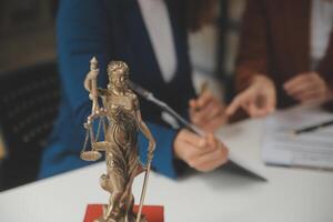 Lawyer, legal advisor, businessman brainstorming information on agreement details Business contracts in legal processing books for accuracy in contract documents. joint financial investment. photo