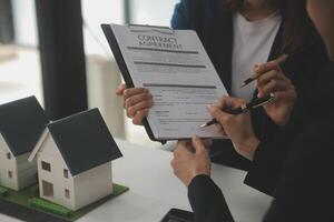 Business Signing a Contract Buy - sell house, insurance agent analyzing about home investment loan Real Estate concept. photo