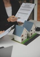 Business Signing a Contract Buy - sell house, insurance agent analyzing about home investment loan Real Estate concept. photo