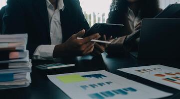 Finance manager meeting discussing company growth project success financial statistics, professional investor working start up project for strategy plan with document, laptop and digital tablet. photo