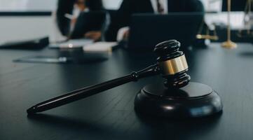 Judge gavel with Justice lawyers having team meeting at law firm background. Concepts of Law and Legal services. photo