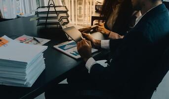 Finance manager meeting discussing company growth project success financial statistics, professional investor working start up project for strategy plan with document, laptop and digital tablet. photo