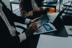 Finance manager meeting discussing company growth project success financial statistics, professional investor working start up project for strategy plan with document, laptop and digital tablet. photo