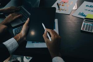 Finance manager meeting discussing company growth project success financial statistics, professional investor working start up project for strategy plan with document, laptop and digital tablet. photo