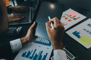 Finance manager meeting discussing company growth project success financial statistics, professional investor working start up project for strategy plan with document, laptop and digital tablet. photo