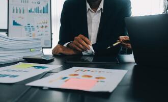 Finance manager meeting discussing company growth project success financial statistics, professional investor working start up project for strategy plan with document, laptop and digital tablet. photo