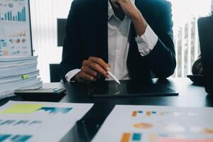 Finance manager meeting discussing company growth project success financial statistics, professional investor working start up project for strategy plan with document, laptop and digital tablet. photo
