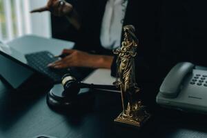 Judge gavel with Justice lawyers having team meeting at law firm background. Concepts of Law and Legal services. photo
