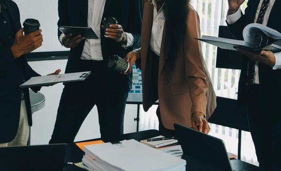 Business team meeting working with new startup project, discussion and analysis data the charts and graphs. Digital tablet, calculator, laptop computer using, Business finance and accounting concept. photo