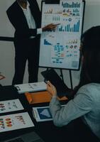 Business team meeting working with new startup project, discussion and analysis data the charts and graphs. Digital tablet, calculator, laptop computer using, Business finance and accounting concept. photo