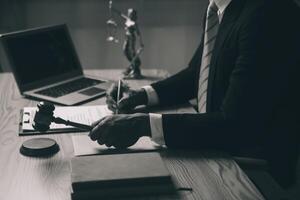 Judge gavel with Justice lawyers having team meeting at law firm background. Concepts of Law and Legal services. photo