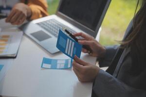 Close up ux developer and ui designer use augmented reality brainstorming about mobile app interface wireframe design on desk at modern office.Creative digital development agency photo