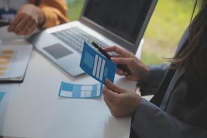 Close up ux developer and ui designer use augmented reality brainstorming about mobile app interface wireframe design on desk at modern office.Creative digital development agency photo