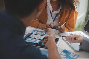 Close up ux developer and ui designer use augmented reality brainstorming about mobile app interface wireframe design on desk at modern office.Creative digital development agency photo