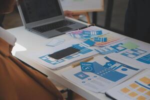 Close up ux developer and ui designer use augmented reality brainstorming about mobile app interface wireframe design on desk at modern office.Creative digital development agency photo