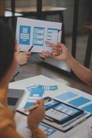 Close up ux developer and ui designer use augmented reality brainstorming about mobile app interface wireframe design on desk at modern office.Creative digital development agency photo