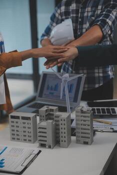Electrical engineer with businessman discussing new project installation solar cell panel on the roof of building. Alternative energy concept. photo