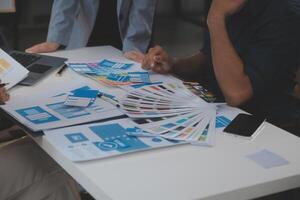 Close up ux developer and ui designer use augmented reality brainstorming about mobile app interface wireframe design on desk at modern office.Creative digital development agency photo