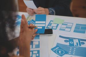 Close up ux developer and ui designer use augmented reality brainstorming about mobile app interface wireframe design on desk at modern office.Creative digital development agency photo