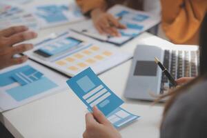 Close up ux developer and ui designer use augmented reality brainstorming about mobile app interface wireframe design on desk at modern office.Creative digital development agency photo