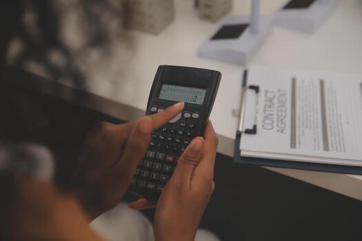 Electrical engineer with businessman discussing new project installation solar cell panel on the roof of building. Alternative energy concept. photo
