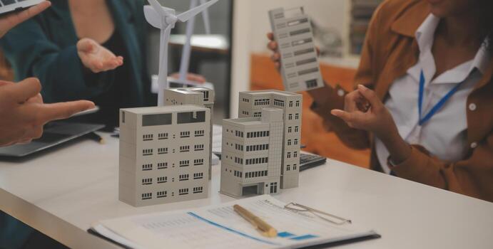 Electrical engineer with businessman discussing new project installation solar cell panel on the roof of building. Alternative energy concept. photo