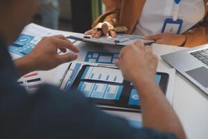Close up ux developer and ui designer use augmented reality brainstorming about mobile app interface wireframe design on desk at modern office.Creative digital development agency photo