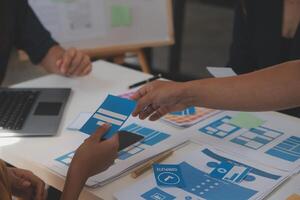 Close up ux developer and ui designer use augmented reality brainstorming about mobile app interface wireframe design on desk at modern office.Creative digital development agency photo