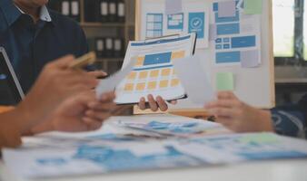 Close up ux developer and ui designer use augmented reality brainstorming about mobile app interface wireframe design on desk at modern office.Creative digital development agency photo