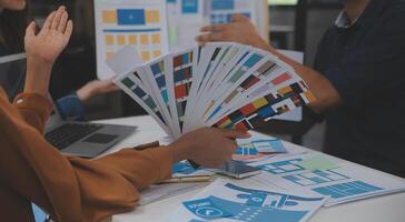 Close up ux developer and ui designer use augmented reality brainstorming about mobile app interface wireframe design on desk at modern office.Creative digital development agency photo