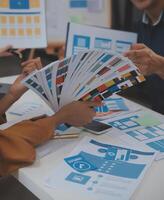Close up ux developer and ui designer use augmented reality brainstorming about mobile app interface wireframe design on desk at modern office.Creative digital development agency photo