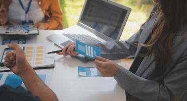 Close up ux developer and ui designer use augmented reality brainstorming about mobile app interface wireframe design on desk at modern office.Creative digital development agency photo