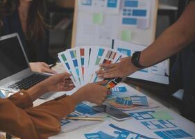 Close up ux developer and ui designer use augmented reality brainstorming about mobile app interface wireframe design on desk at modern office.Creative digital development agency photo