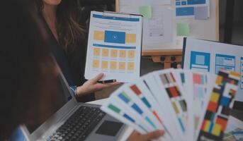 Close up ux developer and ui designer use augmented reality brainstorming about mobile app interface wireframe design on desk at modern office.Creative digital development agency photo