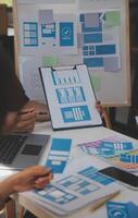 Close up ux developer and ui designer use augmented reality brainstorming about mobile app interface wireframe design on desk at modern office.Creative digital development agency photo