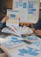 Close up ux developer and ui designer use augmented reality brainstorming about mobile app interface wireframe design on desk at modern office.Creative digital development agency photo