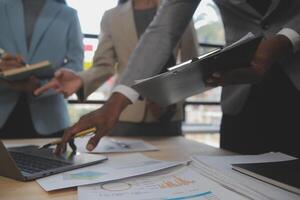 Finance manager meeting discussing company growth project success financial statistics, professional investor working start up project for strategy plan with document, laptop and digital tablet. photo