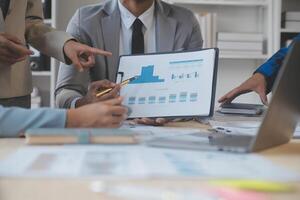 Finance manager meeting discussing company growth project success financial statistics, professional investor working start up project for strategy plan with document, laptop and digital tablet. photo