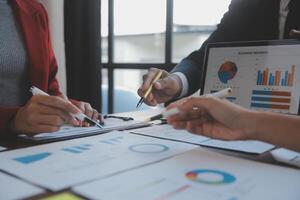 Finance manager meeting discussing company growth project success financial statistics, professional investor working start up project for strategy plan with document, laptop and digital tablet. photo