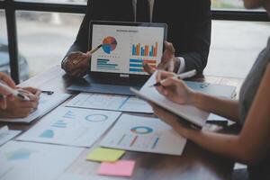 Finance manager meeting discussing company growth project success financial statistics, professional investor working start up project for strategy plan with document, laptop and digital tablet. photo