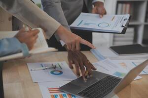Finance manager meeting discussing company growth project success financial statistics, professional investor working start up project for strategy plan with document, laptop and digital tablet. photo