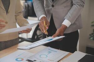 Finance manager meeting discussing company growth project success financial statistics, professional investor working start up project for strategy plan with document, laptop and digital tablet. photo