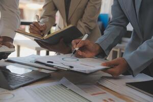 Finance manager meeting discussing company growth project success financial statistics, professional investor working start up project for strategy plan with document, laptop and digital tablet. photo