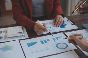 Finance manager meeting discussing company growth project success financial statistics, professional investor working start up project for strategy plan with document, laptop and digital tablet. photo