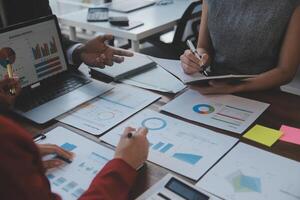 Finance manager meeting discussing company growth project success financial statistics, professional investor working start up project for strategy plan with document, laptop and digital tablet. photo
