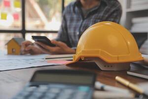 A team of construction engineers talks to managers and construction workers at the construction site. Quality inspection, work plan, home and industrial building design project photo