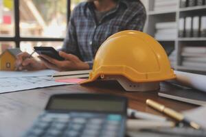 A team of construction engineers talks to managers and construction workers at the construction site. Quality inspection, work plan, home and industrial building design project photo